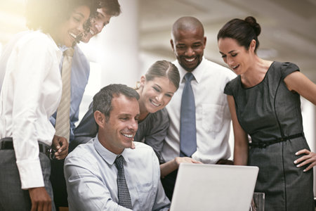 Theyre impressed with his proposal. a group of businesspeople in their office.の写真素材