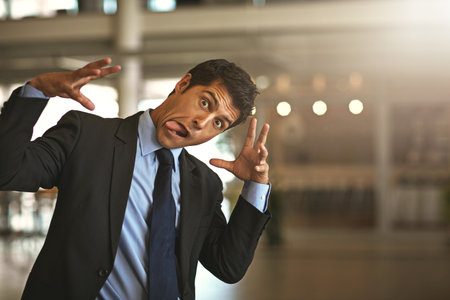 Business can get crazy. Cropped portrait of a businessman gesturing crazily in the office.の写真素材