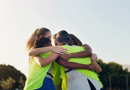 Support, hug and team huddling for hockey, game motivation and sports on a field in Australia. Team building, planning and athlete girls with a circle huddle for teamwork, training and sportの写真素材