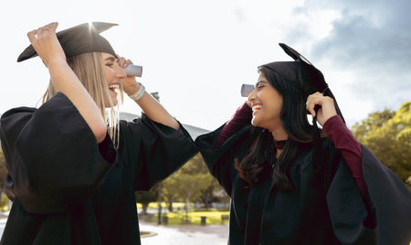 Graduate women, friends and smile together with graduation cap, congratulations and success for studying. University student, gen z girl and excited with diversity, goal and happiness for achievementの写真素材