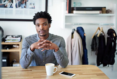 I worked hard to get to this desk. Portrait of a young male designer at his desk.の写真素材
