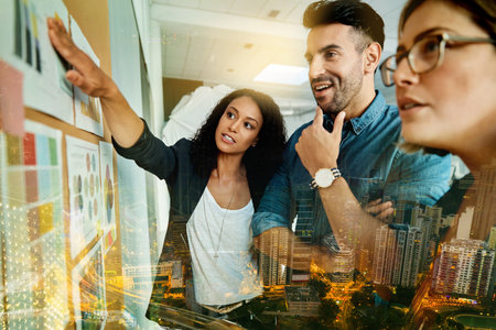 Planning, ideas and overlay of business people with data in a digital marketing meeting at work. Analysis, creative and group of employees with a cityscape, stats and brainstorming a strategyの写真素材