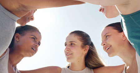 Face, huddle or team with a sports woman and friends standing in a circle together before a game. Fitness, exercise and teamwork with a female group training outside for a competitive sport eventの写真素材