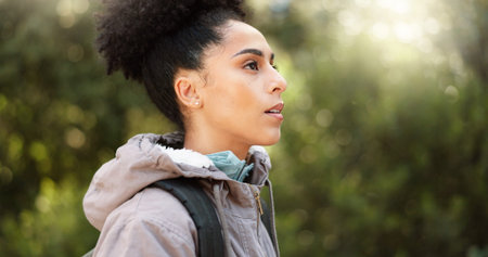 Hiking, thinking and adventure with a black woman in nature, sightseeing while walking on a trail...