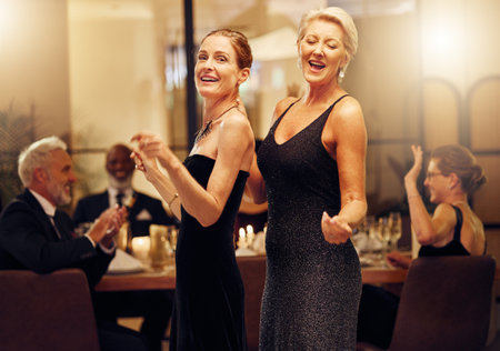 Dance, singing and portrait of women at an event for new years, birthday celebration or party. Smile, happy and mature, elegant and classy friends at a social gala for dancing and to sing at a venueの写真素材