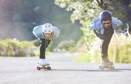 Friends, speed and longboard skating in road, racing downhill with skateboard and helmet for safety. Extreme sports adventure, skateboarding street race and skateboarder ride on mountain pass.の写真素材