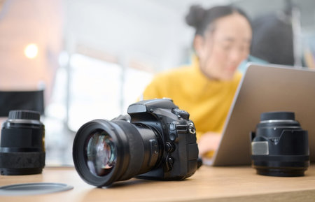 Photography camera, laptop and photographer editing photoshoot, focus on digital art or retouching...