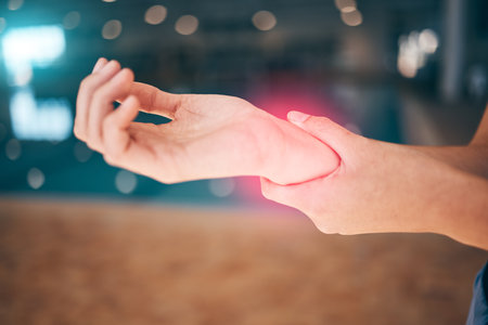 Tendinitis, red pain and wrist of person in sports or swimming training, exercise and workout with muscle risk. Bone injury, athlete or swimmer woman hands for medical check or emergency by poolの写真素材