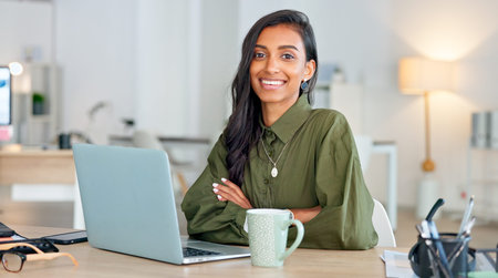 Proud, happy and confident business woman typing on a laptop and turns to look at the camera in her...