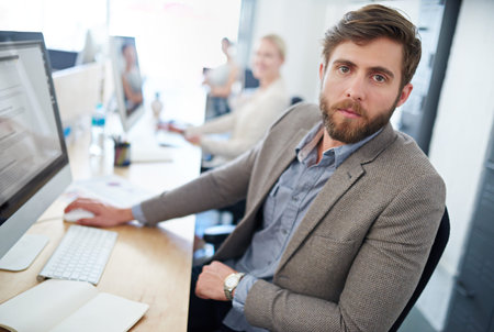Hes one hundred percent focused on the task. a designer at work in an office.