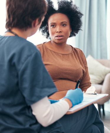 Healthcare, nurse and pregnant woman during a consultation, planning support and medical paperwork. Strategy, insurance and African patient talking to a doctor about health update during pregnancyの写真素材