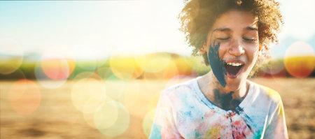 Boy, outdoor and paint splash on face with mockup space by field, grass or nature for holiday in blurred background. Young happy kid, sunshine and excited smile at park, game or countryside vacationの写真素材