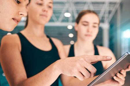 Young athletes looking at tablet, training data for sports with technology and group of people at...