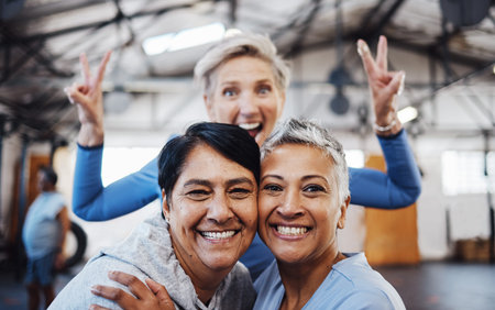 Business women, senior portrait and happiness of company friends in a warehouse with peace sign....