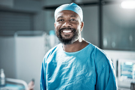Face portrait, black man and doctor in hospital satisfied with career, job and clinic profession. Healthcare, medical professional and confident, proud and happy male surgeon from Nigeria in scrubs.の写真素材
