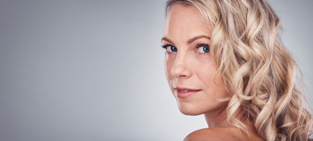 Woman, beauty and portrait smile on mockup for skincare, cosmetics or makeup against a gray studio...