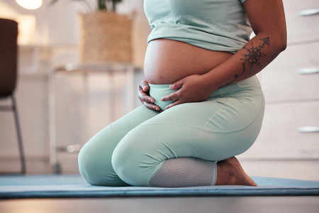 Pregnant, yoga and black woman on mat, stomach and training for healthcare, prenatal and wellness....