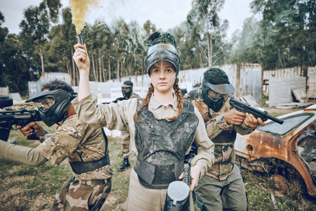 Start, battle and girl with smoke during paintball, military training and army game in Spain. War, alert and woman playing with gear and equipment during a competition, sports and action on a fieldの写真素材