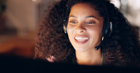 Happy, call center and black woman working in customer support in office at night, friendly and...