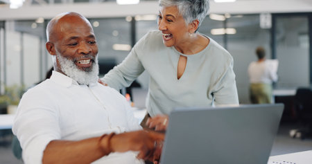 Success, celebration and black man on laptop with employee celebrating goals, target or achievement. Winner, victory and mature business people on computer celebrate winning on stock market in officeの写真素材