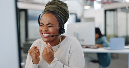 Call center, celebration and woman on computer business sales, telemarketing success and target or survey results of african worker. Office, telecom and winner employee in website support excellenceの写真素材