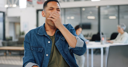 Businessman, yawning or desk sleeping in modern office, digital marketing startup or advertising branding company. Tired, fatigue or exhausted creative designer and laptop technology or bored burnoutの写真素材