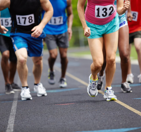 Marathon moments. athletes legs during a race.の写真素材