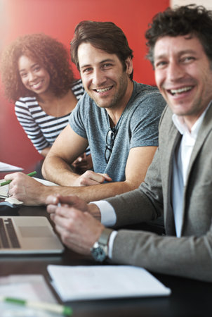 Were a like-minded group. Portrait of a group of colleagues having a meeting in a boardroom.の写真素材