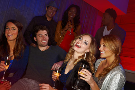 Catching up with old friends. A group of friends having drinks in a nightclub.