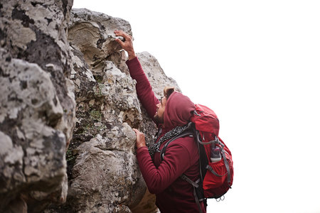 Scaling the mountain. a young man enjoying a hike through the mountains.