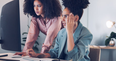 Computer, black african american woman or manager coaching, training or helping an employee with mentorship at office desk. Leadership, collaboration or worker with a question talking or speaking ofの写真素材