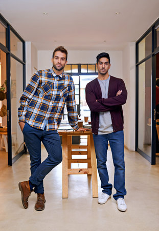 Passionate about design. Portrait of two male designers standing in their creative workspace.