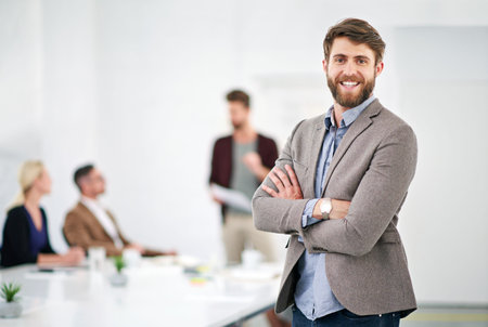 I have the best team behind me. Portrait of a young businessman in an office with colleagues in the...