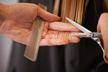 Hair professional at work. Closeup shot of a woman having her hair trimmed at a salon.の写真素材