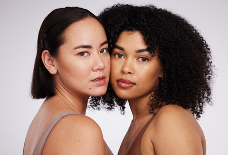 Women, face and diversity with portrait, skin color and skincare inclusion with beauty isolated on studio background. Natural cosmetics, glow and dermatology, unique cosmetic and facial careの写真素材