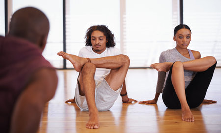 Stretching makes resilient dancers. a group of young dancers rehearsing together in a studio.