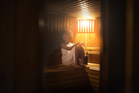 Absolute bliss...A young woman relaxing in the sauna at a spa.の写真素材