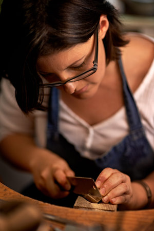 Concentration is key. An artist creating something out of wood.