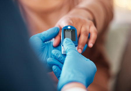 Closeup of hand, pulse device on finger and doctor checkup for blood oxygen level measurement. Medical professional testing in clinic, healthcare with digital meter or nurse consulting african womanの写真素材