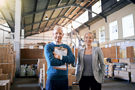 We ensure your shipment arrives on time. Portrait of two mangers standing in a large warehouse.