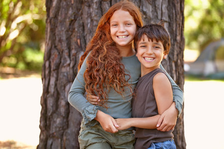 Friends for life. A little boy and girl embracing outside iwhile on camp.の写真素材