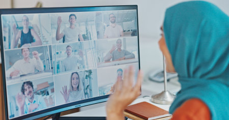 Corporate muslim woman, wave and video call with computer, smile and online communication in office....