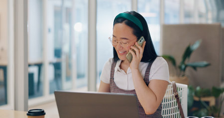 Phone call, communication and business woman writing notes in office. Laptop, cellphone and Asian...