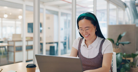 Asian executive, woman and video call with wave, smile and communication with laptop app, internet or web. Corporate leader, digital contact and video conference on computer for business consultingの写真素材