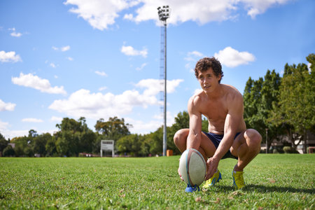 Its all about skill. A young rugby player preparing for a kick on a sports field.の写真素材