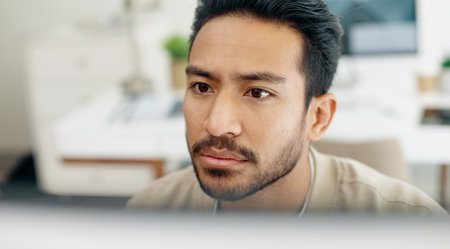 Asian man, face thinking and idea with computer, planning and brainstorming for success in programming. Tech startup worker, executive focus and solution with innovation by desktop pc in workplaceの写真素材