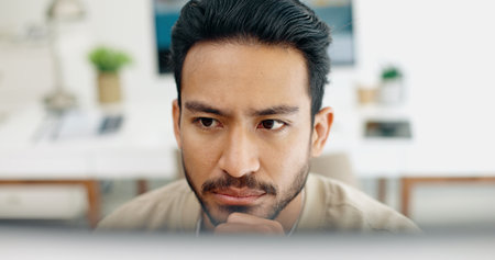 Asian man, face thinking and idea with computer, planning and brainstorming for success in programming. Tech startup worker, executive focus and solution with innovation by desktop pc in workplaceの写真素材