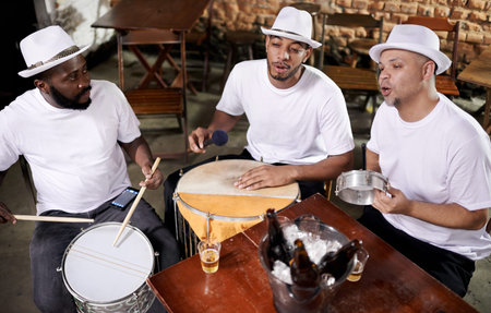 Playing to the Brazilian beat. a band playing their percussion instruments in a Brazilian setting.