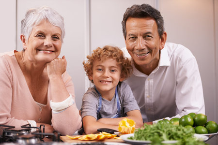 Kitchen quality time. A young boy cooking in the kitchen with his grandparents.