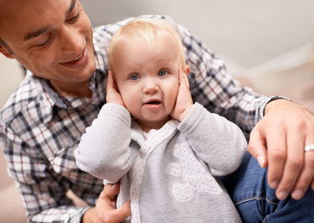 Admiring his beautiful daughter. A young father spending quality time his baby daughter.